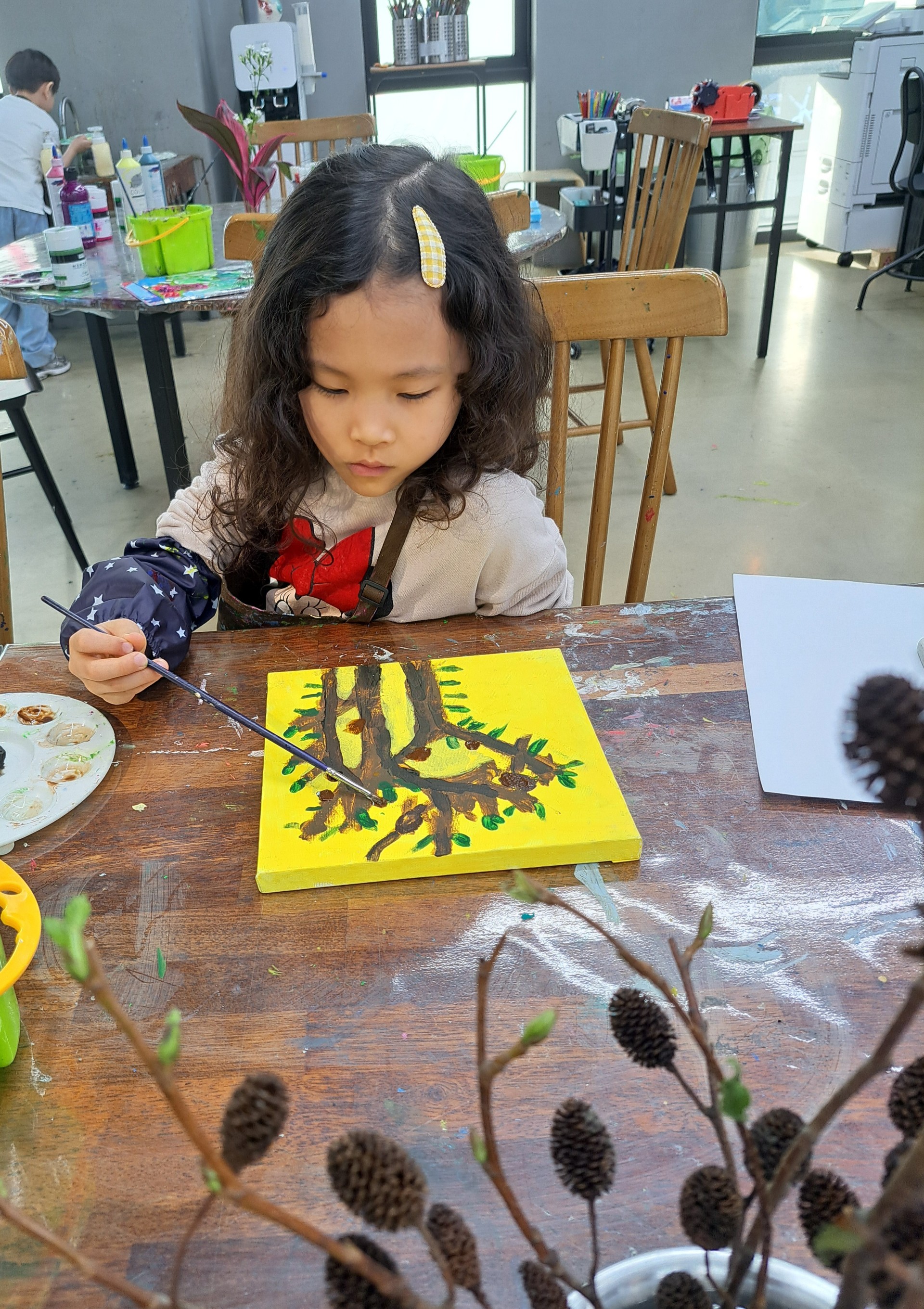 Focused and creative - painting a tree at art class