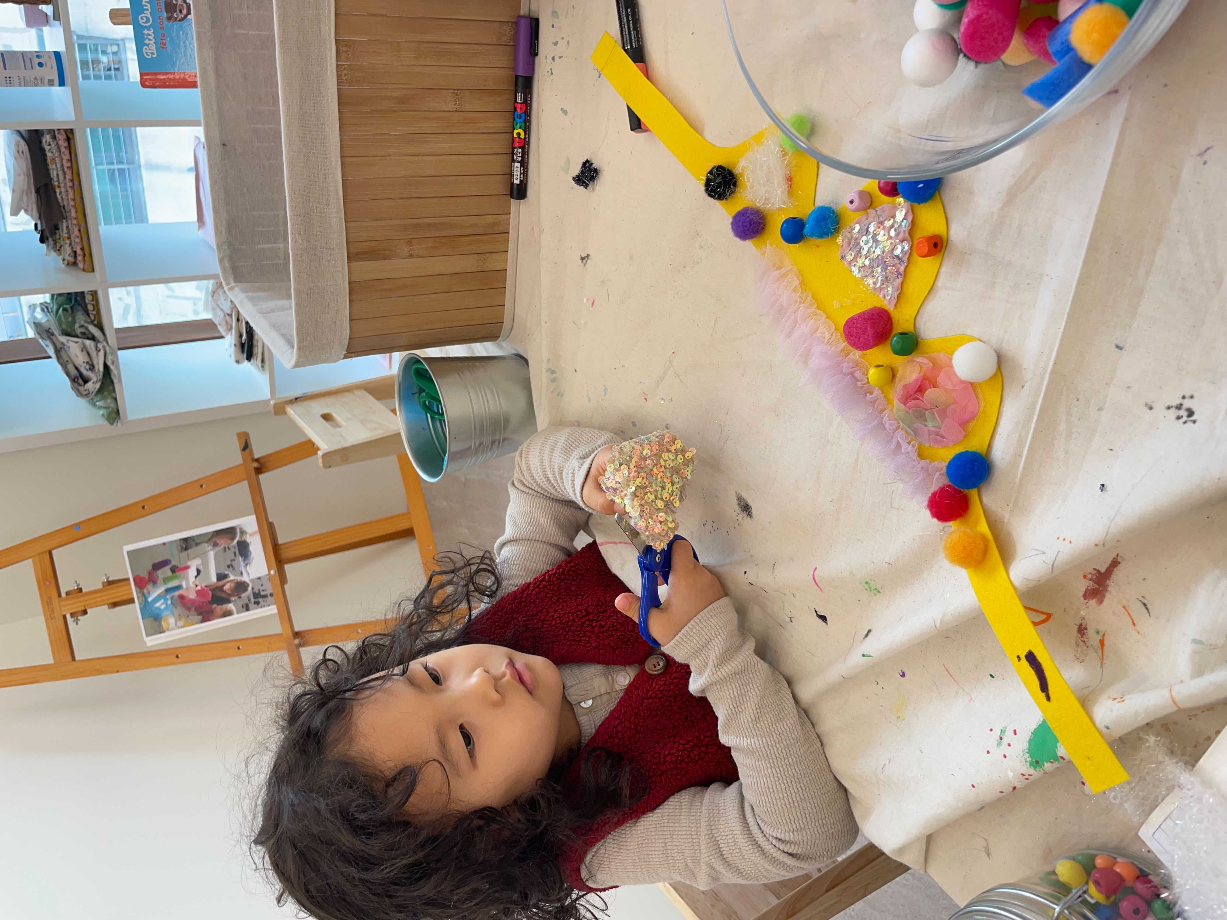 Crafting with scissors, sequins, and pom-poms - developing fine motor skills
