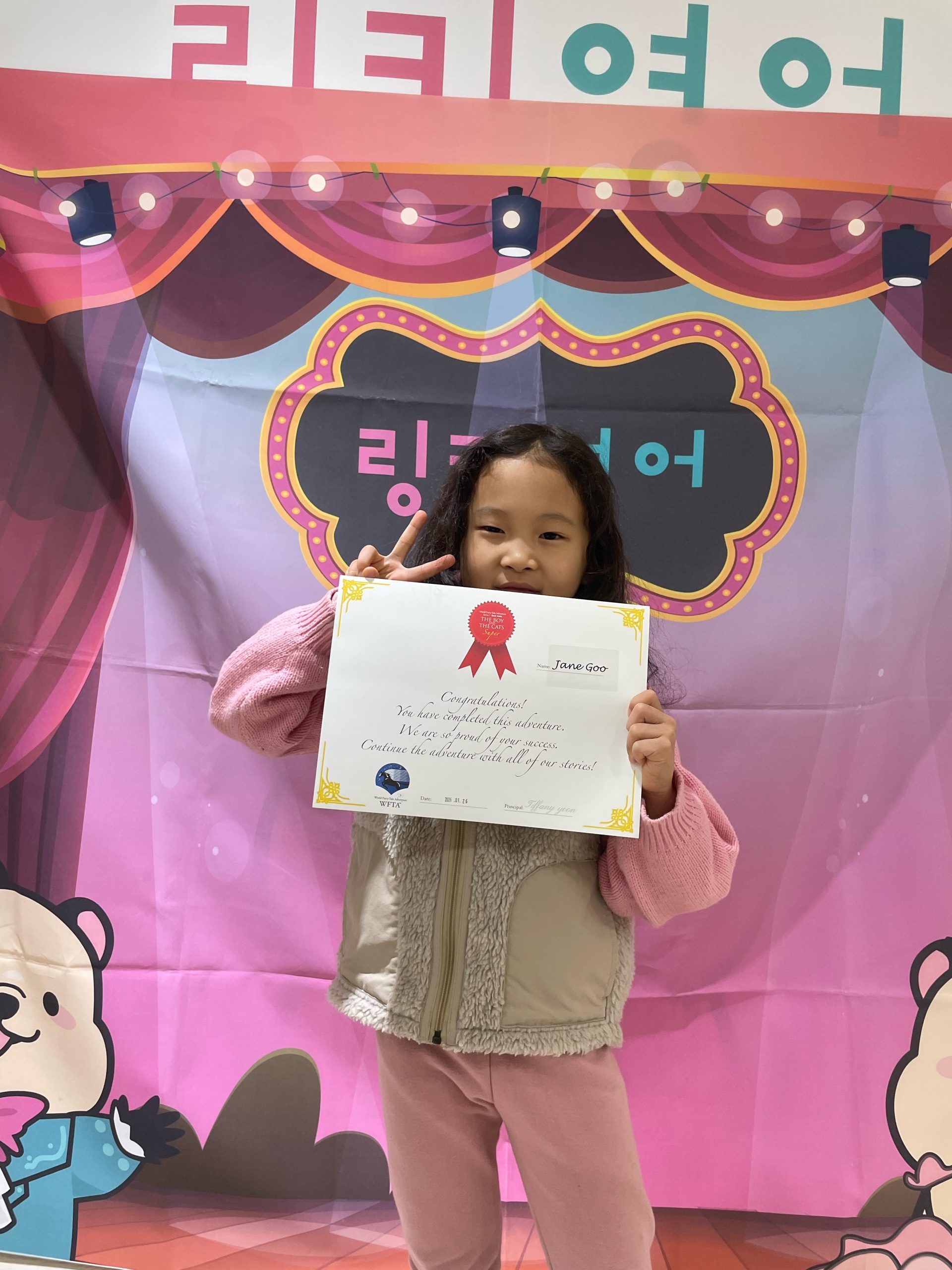 Celebrating her English reading achievement certificate